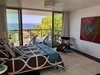 Modern home with Bedroom, Dark Hardwood Floor, Chair, Bed, Rug Floor, Ceiling Lighting, and Bamboo Floor. The master bedroom connects to the outside effortlessly. Photo 18 of Farwell