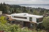 Modern home with Exterior, House Building Type, Prefab Building Type, Tile Roof Material, Concrete Siding Material, Metal Siding Material, Flat RoofLine, and Wood Siding Material. Neighborhood looks towards the site and house anchoring the landscape. Photo 2 of Farwell