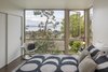 Modern home with Bedroom, Recessed Lighting, Night Stands, Chair, Bed, Rug Floor, Dark Hardwood Floor, and Ceiling Lighting. The guest room's expansive glass creates intimacy with the madrone tree while framing the view. Photo 11 of Farwell