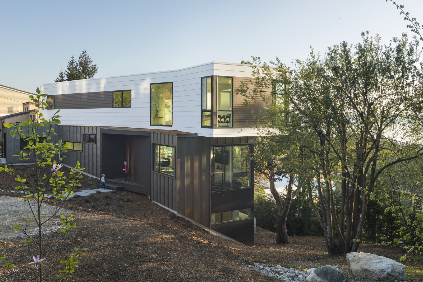 From the edge of the property the graceful entry and landscape gently slope around to a lower yard.