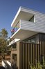 Modern home with Exterior, Flat RoofLine, House Building Type, Concrete Siding Material, Tile Roof Material, Prefab Building Type, Metal Siding Material, and Wood Siding Material. The upper floor volume floats over the corten steel base extending itself towards the view while creating carved spaces. Photo 14 of Farwell