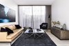Modern home with Living Room, Sofa, Coffee Tables, Light Hardwood Floor, Lamps, and Ceiling Lighting. Canny 'The New' Formal Living Room Photo 10 of The New