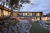 Modern home with Outdoor, Large Patio, Porch, Deck, Grass, Garden, Trees, Walkways, Shrubs, Gardens, Pavers Patio, Porch, Deck, Decking Patio, Porch, Deck, Boulders, Hardscapes, Concrete Patio, Porch, Deck, Stone Fences, Wall, and Hanging Lighting. The South Elevation provides complete transparency through the main level to established gardens beyond Photo of Moat's Corner