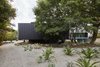 Modern home with Outdoor, Side Yard, Shrubs, and Hardscapes. As a result of its elevation, the bedroom wing allows vegetation to nestle gently under and around with minimal disturbance. Photo 3 of Moat's Corner