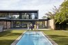 Modern home with Outdoor, Large Pools, Tubs, Shower, Swimming Pools, Tubs, Shower, Back Yard, Stone Patio, Porch, Deck, Grass, Gardens, Shrubs, Pavers Patio, Porch, Deck, Walkways, and Trees. The VDG team celebrating the launch of Moat’s Corner, poolside, champagne in hand, ‘Slim Aarons’ style Photo 5 of Moat's Corner