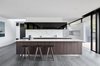 Modern home with Kitchen, Ceiling Lighting, Range Hood, Undermount Sink, Cooktops, Stone Slab Backsplashe, Marble Counter, Wood Cabinet, Marble Backsplashe, Porcelain Tile Floor, and Recessed Lighting. Named after a local pioneering family, Moat's Corner is a contemporary residence located on 53 acres on Melbourne's Mornington Peninsula. Photo 7 of Moat's Corner