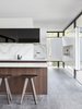 Modern home with Kitchen, Ceiling Lighting, Cooktops, Range Hood, Undermount Sink, Wood Cabinet, Marble Counter, Porcelain Tile Floor, Recessed Lighting, and Marble Backsplashe. Encased in glazing, the residence welcomes an abundance of warm, natural light throughout. Photo 8 of Moat's Corner