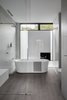 Modern home with Ceiling Lighting and Porcelain Tile Floor. A look at the bathroom sited in the cantilevered bedroom wing. Photo 11 of Moat's Corner