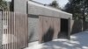 Modern home with Exterior, Flat RoofLine, Wood Siding Material, Brick Siding Material, House Building Type, and Shingles Roof Material. However, in this architectural project, you can feel reasonable composition. Photo 4 of The Grey House