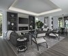 Modern home with Living Room, Ceiling Lighting, Sofa, Light Hardwood Floor, Coffee Tables, Chair, and Recessed Lighting. The spacious great room in this Franklin home, completed in 2017, is open to the kitchen and features a linear fireplace on a floating honed limestone hearth, supported by hidden steel brackets, extending the full width between the two floor to ceiling windows. The custom oak shelving forms a display case with individual lights for each section allowing the homeowners to showcase favorite art objects. The ceiling features a step and hidden LED cove lighting to provide a visual separation for this area from the adjacent kitchen and informal dining areas. The rug and furniture were selected by the homeowners for everyday comfort as this is the main TV watching and hangout room in the home. A casual dining area provides seating for 6 or more and can also function as a game table. In the background is the 3 seasons room accessed by a floor-to-ceiling sliding door that opens 2/3 to provide easy flow for entertaining. Photo 11 of Contemporary Michigan Lake Home