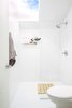 Modern home with Ceiling Lighting and Concrete Floor. The huge skylight in the bathroom floods the space with light. It's great when planning what to wear while looking up at the morning sky for weather too. Photo 19 of 111 House