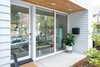 Modern home with Exterior, House Building Type, Metal Roof Material, Concrete Siding Material, and A-Frame RoofLine. Front of the 111 House with keyless entry for easy coming and going! Photo 2 of 111 House
