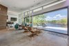 Modern home with Living Room, Sectional, Ceiling Lighting, Ottomans, Recliner, Recessed Lighting, Gas Burning Fireplace, and Concrete Floor. View from Great Room to Lake. Photo 6 of Jafari Residence