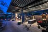 Modern home with Kitchen, Wood Cabinet, Medium Hardwood Floor, and Ceiling Lighting. While the structure itself is given dominance, emphasizing the engineering, the industry feel is softened by natural light, custom cabinetry and a muted, monochromatic palette throughout.
“Even though you have really high ceilings and lots of glass, it's still very warm inside,” Clarke explains in the Realtor.com story. “Sometimes contemporary homes aren't. This one is. It's just pretty spectacular.”
Photo 5 of Iconic Modernism by Barton Myers
