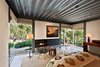Modern home with Bedroom, Bed, Concrete Floor, Chair, Floor Lighting, Dresser, Rug Floor, Ceiling Lighting, and Accent Lighting. The second wing features both bedrooms each with clerestory windows to capture the natural light in sunny Montecito and frame the magnificent views. Photo 8 of Iconic Modernism by Barton Myers