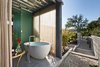 Modern home with Bath Room, Freestanding Tub, and Concrete Floor. Each bedroom is complete with en-suite baths. Both include clerestory windows that capture the natural light and embrace the stunning views. Photo 9 of Iconic Modernism by Barton Myers