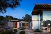 Modern home with Exterior, House Building Type, Flat RoofLine, Glass Siding Material, Metal Siding Material, and Metal Roof Material. Created from steel and glass, with emphasis on space and ground, light and shadow, this amazing representation of High-tech Modernism is innovative in its design, and nothing short of stunning. Featuring huge wall-size multi-pane doors that retract -- not horizontally, but vertically – and integrate with the home’s ceiling, opening entire rooms to the property's enchanting Zen-like gardens. There are large sliding glass doors as well, and expanses of clerestory windows. Photo of Iconic Modernism by Barton Myers