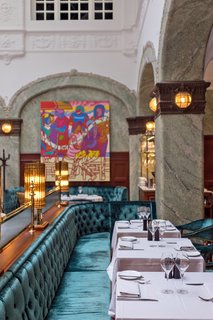 Our journey begins at Stockholm's Bank Hotel, which is set in a 1910 building that originally served as the head office of the Södra Sverige Banking company. The hotel's common areas tie it to the city—pictured here is Bonnie's, a ground-floor restaurant with a sumptuous daylit interior that draws travelers and locals alike.