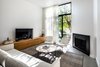 Modern home with Living Room, Recessed Lighting, Console Tables, Ceramic Tile Floor, and Gas Burning Fireplace. Living Room Photo 6 of Throckmorton Renovation