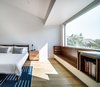 Modern home with Bedroom, Bed, Recessed Lighting, Bench, Light Hardwood Floor, and Ceiling Lighting. Master Bedroom Photo 14 of Throckmorton Renovation