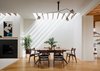 Modern home with Dining Room, Table, Pendant Lighting, Ceiling Lighting, Light Hardwood Floor, Chair, and Medium Hardwood Floor. Skylights, strategically placed along the northern walls over existing exposed framing, animate the original volume of the house with a changing play of light and shadow throughout the day. Photo of Noe Valley Residence