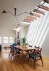 Modern home with Dining Room, Pendant Lighting, Light Hardwood Floor, Table, Chair, Medium Hardwood Floor, and Ceiling Lighting. Reinterpreted and expanded in a modern vocabulary, the house was transformed into a relaxed and inviting family home. Photo 2 of Noe Valley Residence