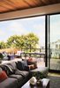 Modern home with Outdoor, Wood Patio, Porch, Deck, Rooftop, and Small Patio, Porch, Deck. Doors frame views to the east that allow the living spaces and kitchen to open directly to a generous deck that celebrates the relationship between indoors and out. Photo 5 of Noe Valley Residence