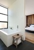 Modern home with Bath Room, Porcelain Tile Floor, Subway Tile Wall, and Soaking Tub. The master bathroom window placements make the small space live bigger. Photo 6 of Noe Valley Residence