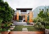 Modern home with Outdoor, Back Yard, Gardens, Grass, Walkways, Trees, Hardscapes, Shrubs, Raised Planters, and Flowers. A single sloped roof, paired with 11' tall sliding doors defines the addition at the rear. Photo 7 of Noe Valley Residence