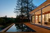 A serene, spa-like exterior offers sweeping views of the surrounding landscape. The home's solar thermal panels preheat the water used throughout the home, including the pool water. Photo 8 of Modern-Day California Ranch House modern home