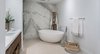 Modern home with Bath Room, Ceramic Tile Floor, Ceiling Lighting, Recessed Lighting, Enclosed Shower, Soaking Tub, Freestanding Tub, Stone Slab Wall, Stone Counter, and Undermount Sink. 121 Marina Ocean Reef Bathroom featuring Aquatica Bath freestanding soaking tub Photo of 121 Marina Ocean Reef