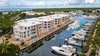 Modern home with Exterior, Beach House Building Type, Metal Roof Material, Boathouse Building Type, Flat RoofLine, Apartment Building Type, and Stucco Siding Material. 121 Marina Ocean Reef Exterior Photo 3 of 121 Marina Ocean Reef