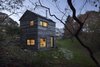 Modern home with Exterior, Tiny Home Building Type, Gable RoofLine, and Wood Siding Material. The reclaimed hickory facade of the Micro Cabin by BC-OA is punctured by windows that overlook National Forest Service land. Photo of Micro Cabin