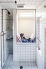 Modern home with Bath Room, Subway Tile Wall, Ceramic Tile Floor, and Open Shower. Occupying the perch visible through the open shower Photo 6 of Micro Cabin