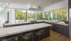 Modern home with Kitchen, Wine Cooler, Ceiling Lighting, Marble Counter, Light Hardwood Floor, Stone Tile Backsplashe, Refrigerator, Ice Maker, Marble Backsplashe, Beverage Center, Range Hood, Microwave, Drop In Sink, Wood Cabinet, Laminate Cabinet, Pendant Lighting, Dishwasher, and Range. Kitchen Photo 10 of Indian Hill Residence