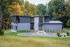 Modern home with Exterior, House Building Type, Stucco Siding Material, Flat RoofLine, Metal Roof Material, Metal Siding Material, and Wood Siding Material. Front Exterior Photo of Indian Hill Residence