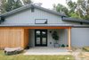 Modern home with Exterior, Metal Roof Material, House Building Type, and Metal Siding Material. The original siding of the garage was maintained where possible in the effort to keep costs down and to respect the original use of the building. Existing trimwork remained but received a fresh coat of paint. The garage door was relocated from the left side of the building and freshed up with paint to match the exterior siding. Photo of Vashon Hangar Conversion