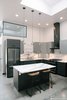 Original concrete floors were filled, and polished, allowing blemishes and wear to remain. The kitchen was designed to reflect the simplicity of island life, the dreamy nature of the owner's love for the coast and open fields, and the industrial origins of the home. Photo 3 of Vashon Hangar Conversion modern home