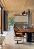 The woodwork in the Chilmark House dining room is especially stunning; Schiller Projects designed, built, and collaborated on many of the freestanding furniture pieces in the house Photo 12 of Chilmark House modern home
