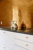 Modern home with Kitchen, Ceiling Lighting, Metal Backsplashe, Cooktops, White Cabinet, and Engineered Quartz Counter. Kitchen backsplash Photo 8 of Catskills House