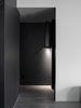 Modern home with Hallway and Porcelain Tile Floor. A hall light detail that discretely illuminates the floor of the black hallway. Photo 10 of Details