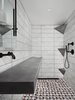 The 8-foot drain-less sink by Compound Concrete which waterfalls into the linear shower drain. They also created custom corner shelves which act as a footrest, a shelf, and the top one is actually a waterfall shower head. Photo 12 of Details modern home