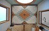 Modern home with Bedroom, Ceiling Lighting, and Bed. The bottom of the bed features a Southwest-inspired pattern that the Parhams designed together. "We wanted to have something beautiful to look at while sitting on the couch if the bed was raised up," says Greg. Photo 3 of The San Juan Tiny House