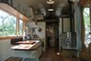 Modern home with Living Room, Coffee Tables, Ceiling Lighting, Bench, Pendant Lighting, Light Hardwood Floor, and Wood Burning Fireplace. The Kimberley woodstove is designed specifically for tiny houses and very small spaces. Photo 7 of The San Juan Tiny House