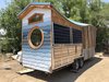Modern home with Exterior, Wood Siding Material, Tiny Home Building Type, Metal Roof Material, Metal Siding Material, and Curved RoofLine. Exterior with porch folded in Photo 8 of The San Juan Tiny House