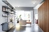 Modern home with Living Room, Bookcase, Sofa, Ceiling Lighting, Accent Lighting, Concrete Floor, and Bench. From the apartment entrance Photo 3 of Nahmani Tel Aviv Apartment