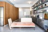 Modern home with Living Room, Bookcase, Concrete Floor, Ceiling Lighting, Wall Lighting, Bench, and Sofa. Living room looking to the entrance. Sofa and Book shelves designed by the architects. Photo 4 of Nahmani Tel Aviv Apartment