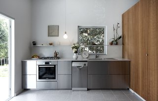 Stainless steel Ikea kitchen elevated by the cherry wood cabinetry