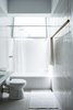 Modern home with Bath Room, One Piece Toilet, Ceramic Tile Floor, Laminate Counter, Wall Mount Sink, Ceiling Lighting, Ceramic Tile Wall, and Alcove Tub. White washed bathroom Photo 8 of Nahmani Tel Aviv Apartment