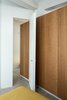 Modern home with Ceiling Lighting and Concrete Floor. Bedroom entry with a custom door designed by the architects. Photo 13 of Nahmani Tel Aviv Apartment
